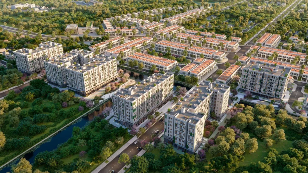 Phối cảnh toàn khu nhà ở xã hội với các tòa chung cư thấp tầng, dãy nhà liền kề và cây xanh nhìn từ trên cao