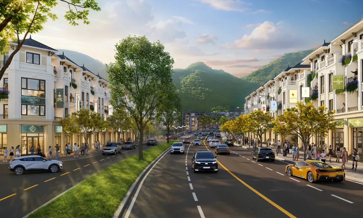Phối cảnh dãy nhà phố thấp tầng dọc trục đường lớn, núi xanh phía sau tại Vinhomes Hải Vân Bay
